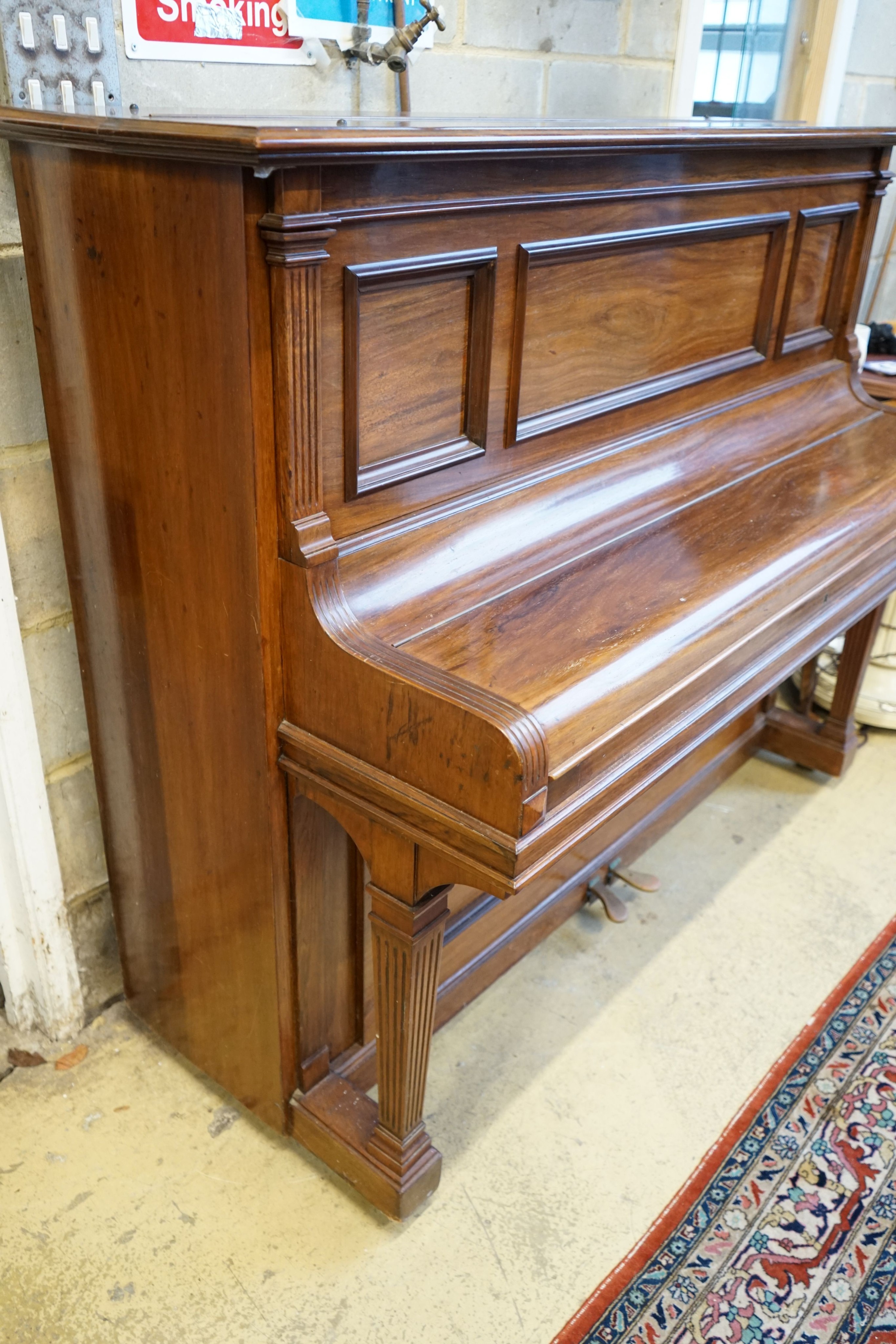 An early 20th century walnut cased Bluthner upright piano, Serial Number 92280